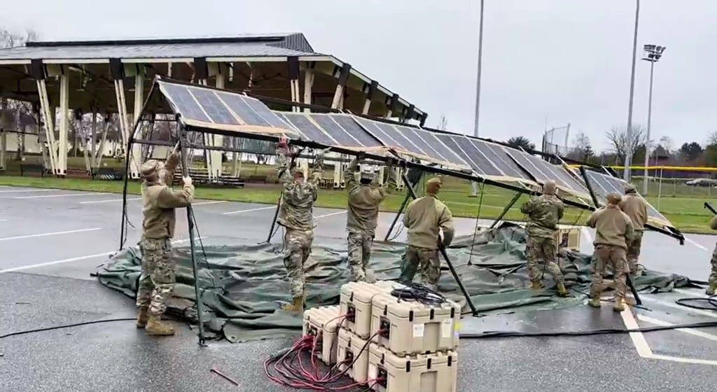 Troops set up Project Arcwater's photovoltaic fabric system, which can produce as much power as it takes to run the average American home. Screenshot from Project Arcwater's Spark Tank video.