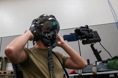 U.S. Air Force Tech. Sgt. Anthony Farnsworth of the 419th Operations Support Squadron adjusts an F-35 helmet during an optical fit training at Hill Air Force Base, Utah, on July 10, 2021. Each helmet is inspected every 105 days and has a 120-day fit check to ensure its functionality and safety. (Senior Airman Erica Webster/Air Force)