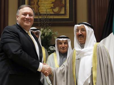 In this March 20, 2019, file photo, U.S. Secretary of State Mike Pompeo, left, shakes hands with Kuwait's Emir Sheikh Sabah Al-Ahmad Al- Jaber Al-Sabah, in Kuwait City, Kuwait.