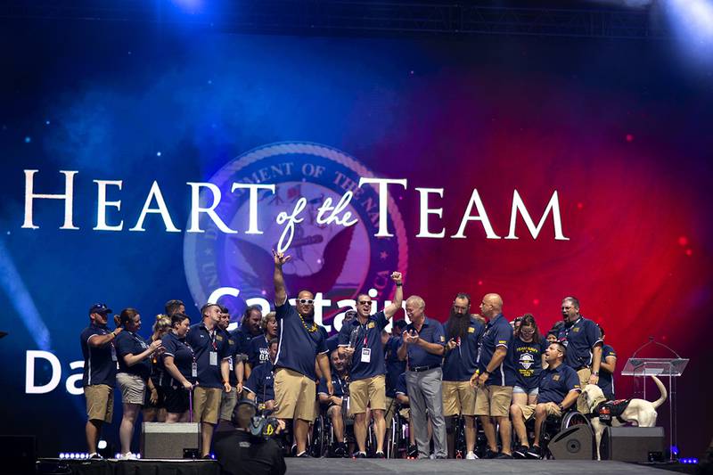 Coast Guard Capt. Daryl Schaffer, center, celebrates with Team Navy after being awarded the Heart of the Team award on June 30 during the closing ceremony of the 2019 DoD Warrior Games in Tampa, Fla.