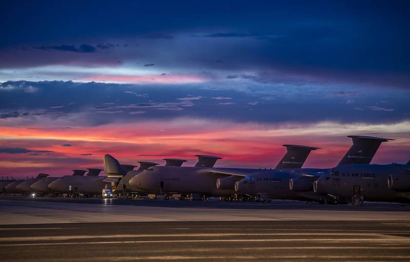 The sun sets over Dover Air Force Base, Del., as airmen work on the flightline Aug. 12, 2020.