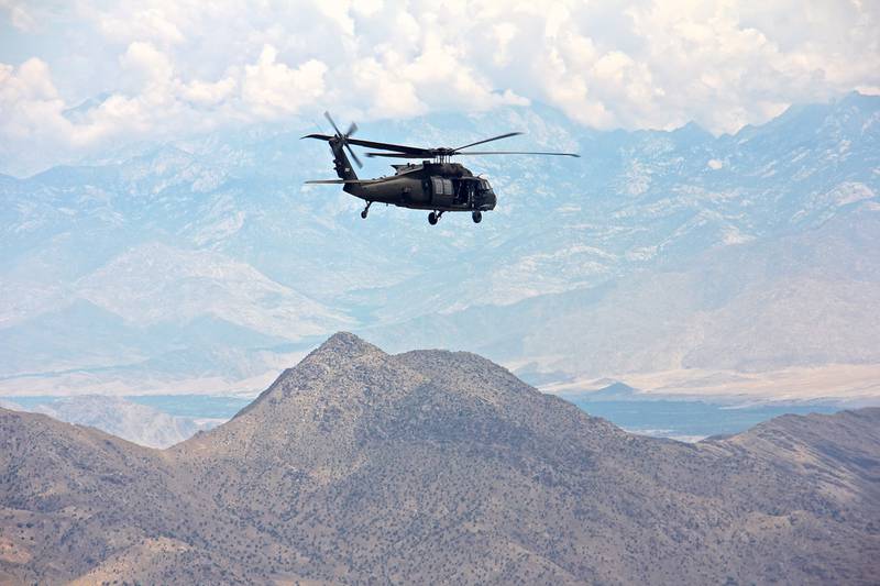 A UH-60 Black Hawk helicopter flies over the rugged terrain of eastern Afghanistan, July 28, 2015.
