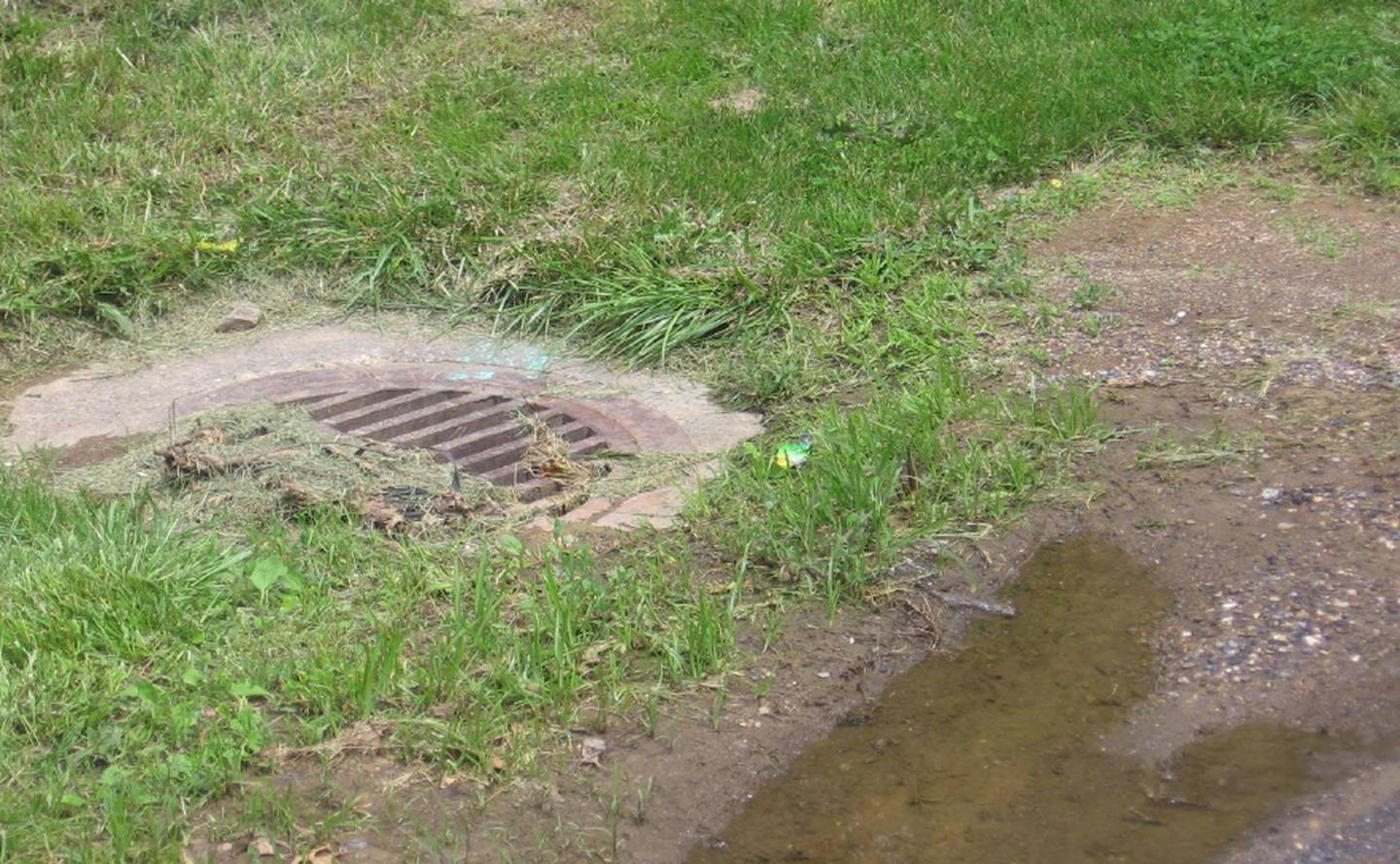 This open stormwater inlet was near where an estimated 2,000 to 3,000 gallons of unsterilized lab wastewater sprayed from an outdoor storage tank at Fort Detrick.