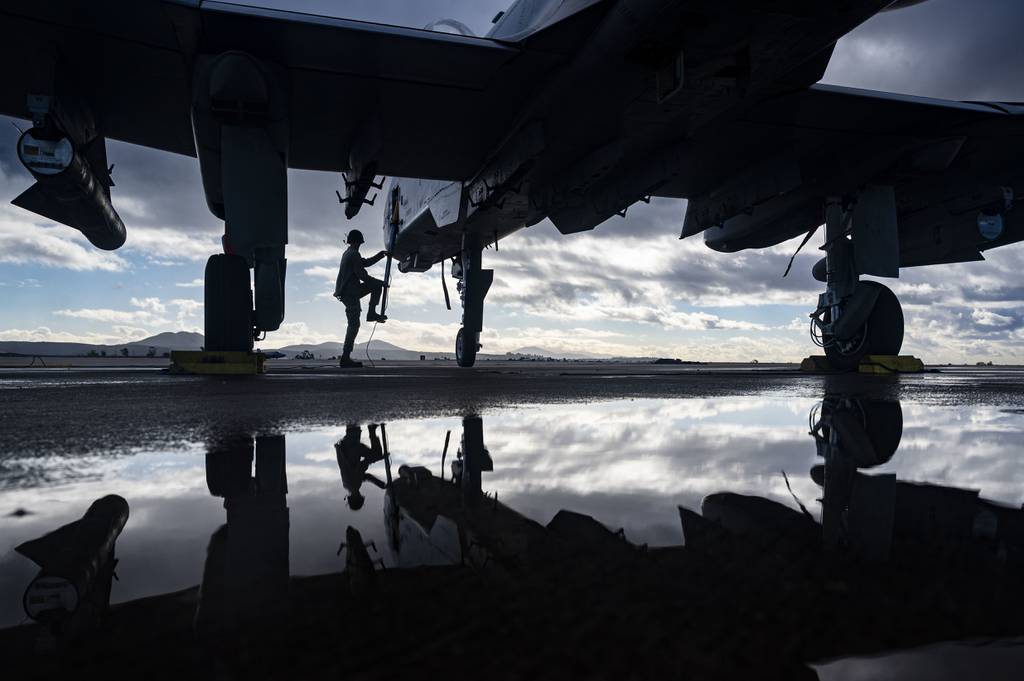 Airman 1st Class Dylan Prusso, 75th Fighter Generation Squadron crew chief, Moody Air Force Base, Ga., climbs up onto an A-10C Thunderbolt II during exercise Green Flag-West 23-02 at Marine Corps Air Station Miramar, Calif., Nov. 9, 2022. The 549th Combat Training Squadron completed the Green Flag-West exercise Nov. 2-9, integrating U.S. Navy and U.S. Air Force command and control, tactical units, and intelligence, surveillance and reconnaissance, while operating from multiple locations across the West Coast. (Senior Airman Zachary Rufus/Air Force)