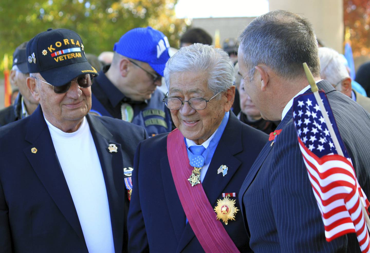 People stand to honor Medal of Honor recipient Hiroshi Miyamura, center, during a Veterans Day ceremony at the New Mexico Veterans Memorial in Albuquerque, N.M., on Nov. 11, 2014.