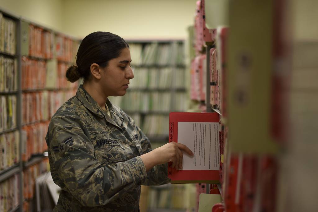 Airman 1st Class Caroline Karaverdian, 9th Medical Group outpatient technician, files a folder in the patient health record department at the clinic at Beale Air Force Base, Calif., Feb. 4, 2020. On June 20 the 9th MDG will be going all-digital by transitioning to a new electronic health record called Military Health System GENESIS.