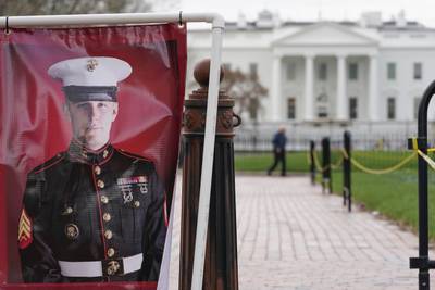 A poster photo of U.S. Marine Corps veteran and former Russian prisoner Trevor Reed stands in Lafayette Park near the White House, March 30, 2022, in Washington.