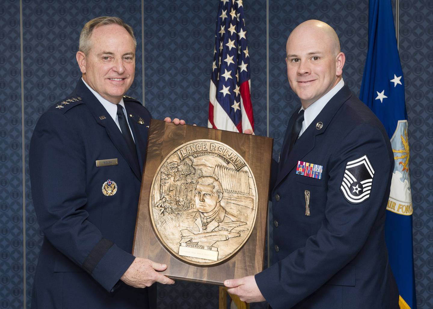 Gen. Mark. A Welsh III, the Air Force chief of staff at the time, presents the Lance P. Sijan Leadership award to then-Senior Master Sgt. Justin Deisch during a ceremony in the Pentagon, Washington. D.C., April 7, 2016. Deisch was a material flight chief assigned to the 705th Munitions Squadron at Minot Air Force Base, N.D., and led 103 personnel across the only munitions squadron supporting the nuclear triad. (Jim Varhegyi/Air Force)