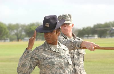 Staff Sgt. Nicole Saulsberry, a military training instructor with the 323rd Training Squadron, and her flight pass in review during a basic military training graduation ceremony in 2008 at Lackland Air Force Base in Texas. (Alan Boedeker/Air Force)