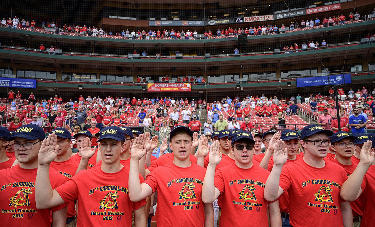 Eighty-one recruits with the 61st Annual Recruit Cardinal Division recite the oath of enlistment at Busch Stadium during a pre-game ceremony, June 6, 2019, in St. Louis.