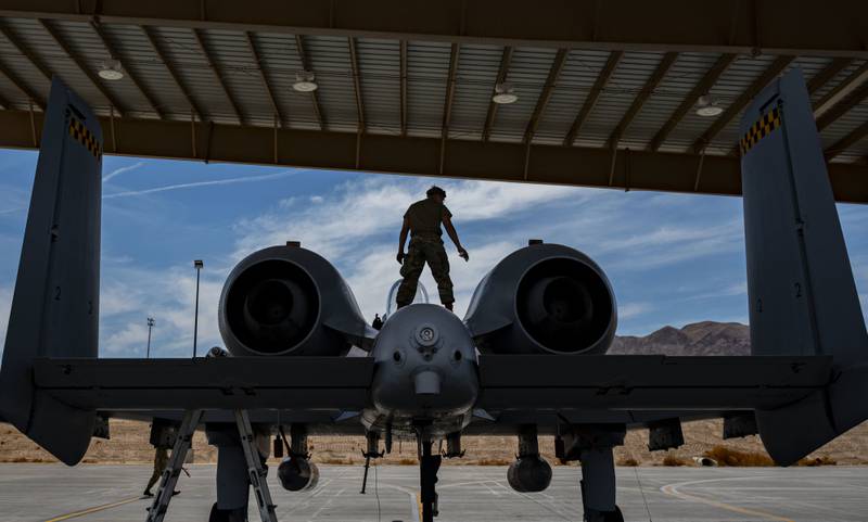 Airman 1st Class Zane Campbell, tactical aircraft maintainer assigned to the 757th Aircraft Maintenance Squadron, performs routine maintenance on an A-10 Thunderbolt II at Nellis Air Force Base, Nevada, June 26, 2021. The A-10 has excellent maneuverability at low air speeds and altitude while providing a highly accurate weapons delivery system. (Airman 1st Class Zachary Rufus/Air Force)