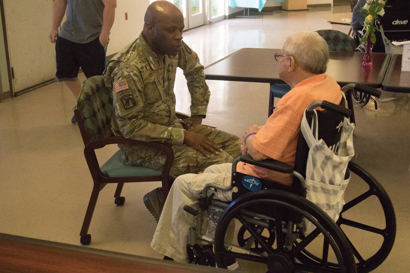 Army Lt. Col. James Key speaks with an Air Force veteran from the Veterans Home in Barstow, California, during a Veterans Home volunteer event in 2019.