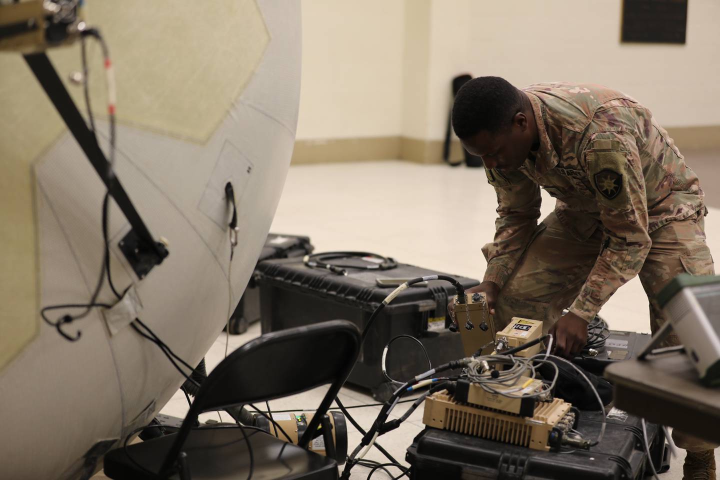 Sgt. Kasey Jones, a soldier from the Florida National Guard’s 146th Expeditionary Signal Battalion, assesses equipment vital to communication in the fight against Hurricane Ian.