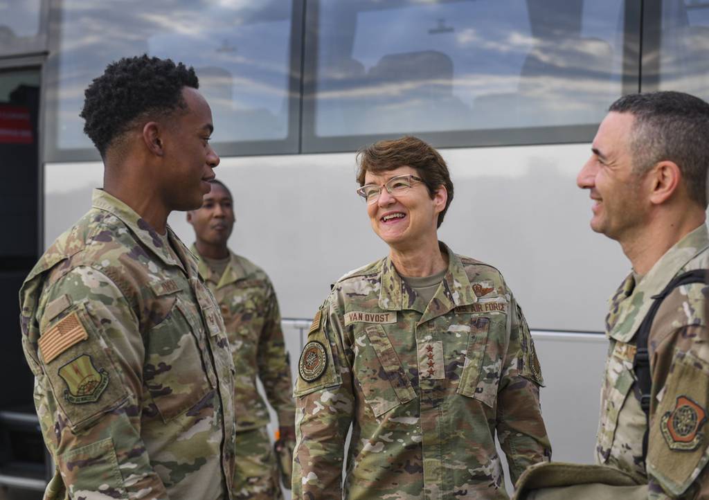 U.S. Air Force Gen. Jacqueline Van Ovost, Air Mobility Command boss, and Chief Master Sgt. Brian Kruzelnick, AMC Command Chief, share a laugh with Staff Sgt. Christopher Lynch from the 521st Air Mobility Operations Wing at Ramstein Air Base, Germany, Sept. 9, 2021. AMC is responsible for providing rapid global mobility in support of national security requirements, including the recent airlift of more than 124,000 evacuees from Afghanistan, many who were processed by the 521st AMOW and Ramstein’s 86th Airlift Wing during Operation Allies Refuge. (Senior Airman Kiaundra Miller/Air Force)
