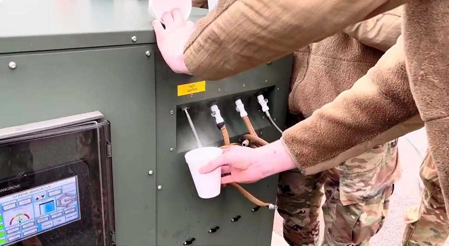 An airman pours a cup of water from Project Arcwater's water harvesting system, which makes drinkable water out of any freshwater, saltwater or moisture in the air. Screenshot of Project Arcwater's Spark Tank pitch video.