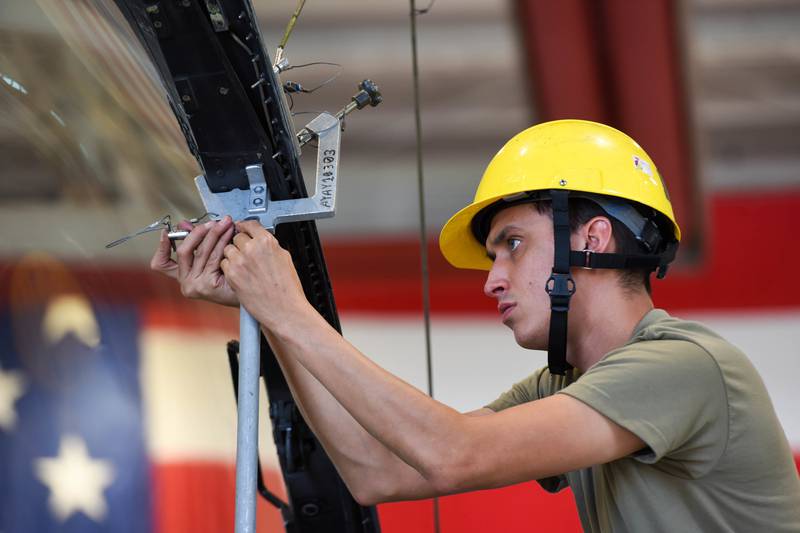 Senior Airman Andres Espinoza, 31st Maintenance Squadron exit journeyman, attaches a canopy support brace to an F-16 Fighting Falcon Aug. 11, 2022 at Aviano Air Base, Italy.  Escape Specialists perform inspections and maintenance on F-16 canopies and egress systems to ensure components function properly in flight and during emergencies.  (Senior Airman Brooke Moeder/Air Force)