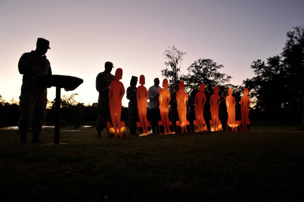 Capt. Sean Kimsey, an officer in the 628th Medical Group, reads stories of fallen airmen during the domestic violence candlelight vigil ceremony at Joint Base Charleston, S.C., Oct. 19, 2015. The ceremony honored all of those who have been affected by domestic violence, both living and deceased, by sharing stories, lighting candles and releasing balloons. (Tech. Sgt. Renae Pittman/Air Force photo)