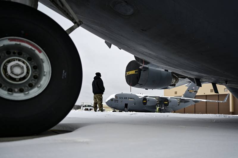 An Airman assigned to the 911th Aircraft Maintenance Squadron conducts a walk-around inspection on a C-17 Globemaster III at the Pittsburgh International Airport Air Reserve Station, Pennsylvania, on Feb. 1, 2021. (Joshua J. Seybert/Air Force)