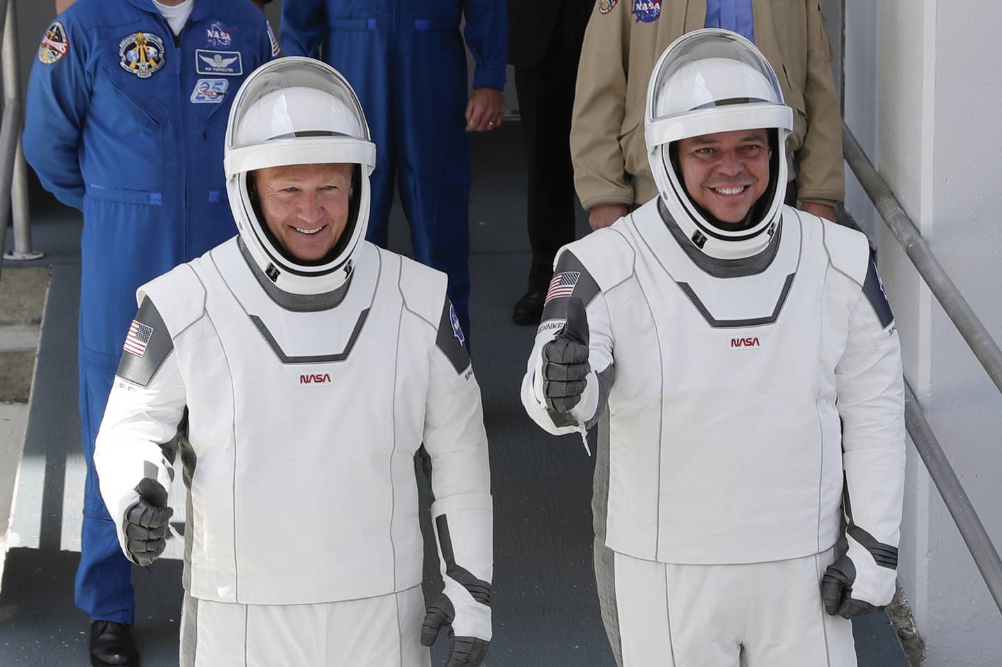 NASA astronauts Douglas Hurley, left, and Robert Behnken walk out of the Neil A. Armstrong Operations and Checkout Building on their way to Pad 39-A, at the Kennedy Space Center in Cape Canaveral, Fla., Saturday, May 30, 2020.
