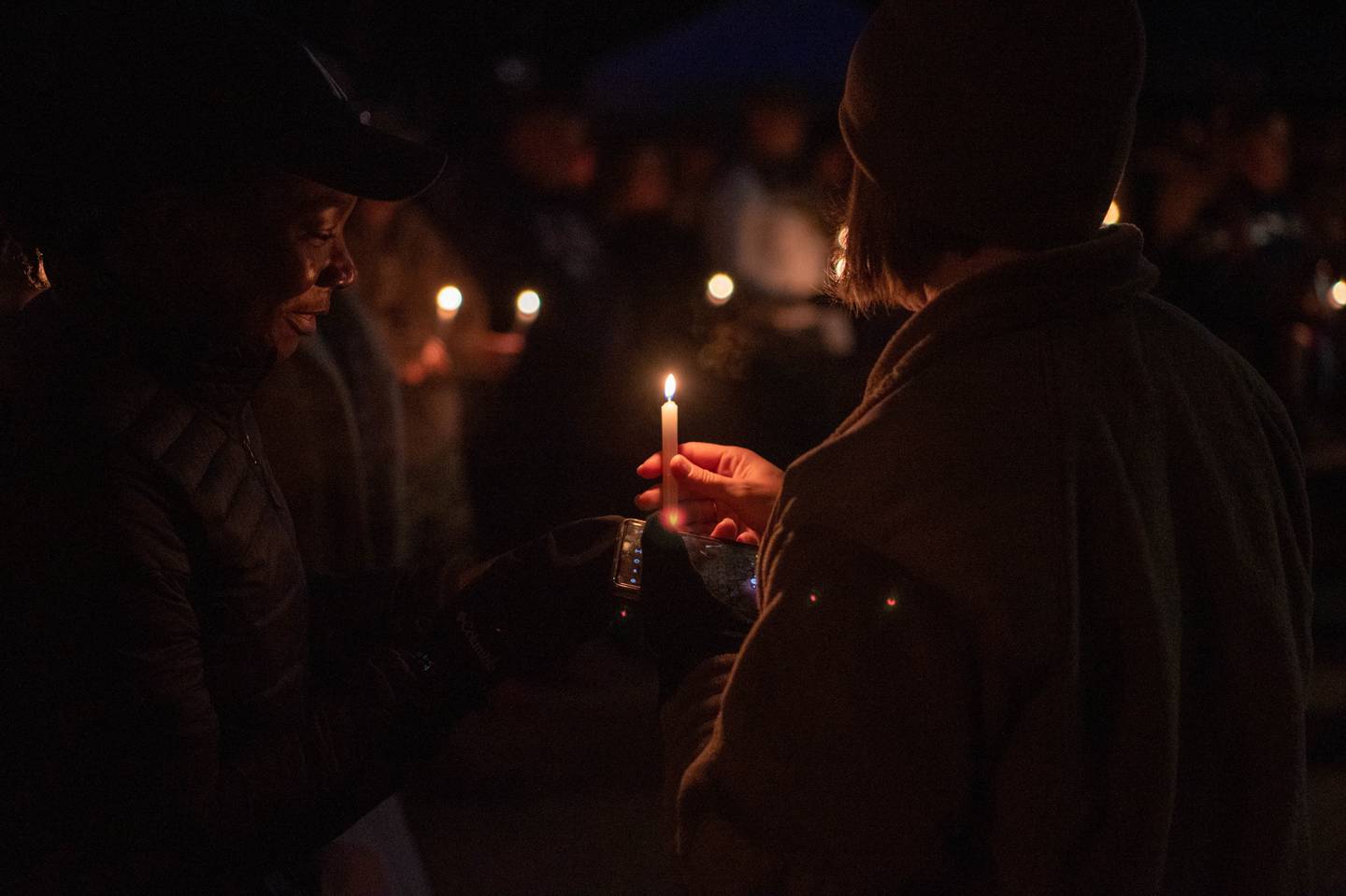 Service members hold candles in honor of those impacted by suicide, domestic violence, sexual assault and harassment at Spangdahlem Air Base, Germany, Sept. 30, 2022.