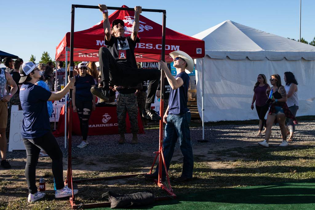 Marines and poolees with Recruiting Station Richmond conduct a pull-up bar challenge during event during the K95 Country Festival in Doswell, Virginia, June 18, 2022.