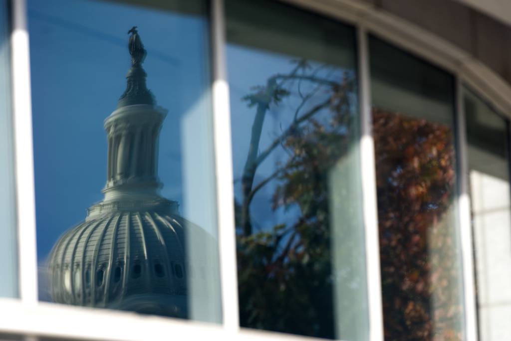 A reflection of the Capitol in Washington, D.C., is seen in a window Nov. 4, 2022.