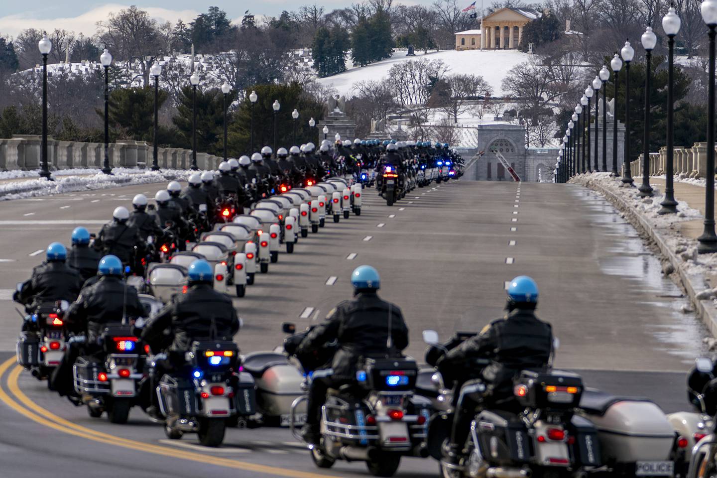 U.S. Capitol Police officers on motorcycles ride ahead of a hearse carrying the remains of U.S. Capitol Police officer Brian Sicknick as it makes its way to Arlington National Cemetery after Sicknick was lying in honor at the U.S Capitol, Wednesday, Feb. 3, 2021, in Washington.