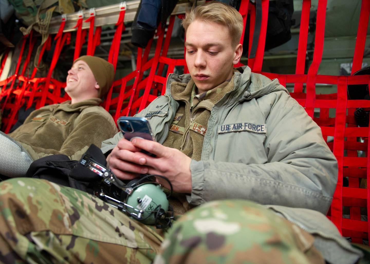 Senior Airman Josiah Goodman, 934th Maintenance Squadron aerospace propulsion technician, texts his girlfriend “goodbye” as he waits for his C-130 to take off at Minneapolis-St. Paul Air Reserve Station on Feb. 16, 2022. Airmen from the wing are deploying in support of a broader effort to demonstrate our commitment to our NATO allies. (Chris Farley/Air Force)