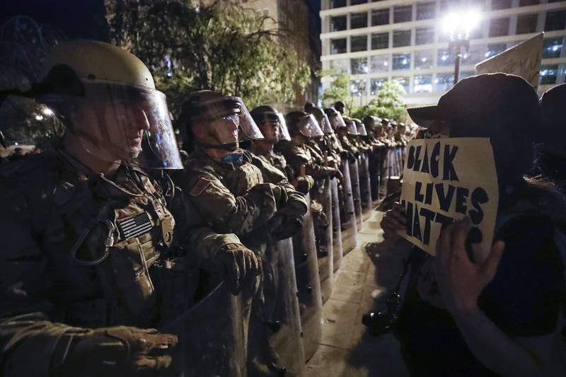 Utah National Guard soldiers line the street as demonstrators gather to protest the death of George Floyd, Wednesday, June 3, 2020, near the White House in Washington.
