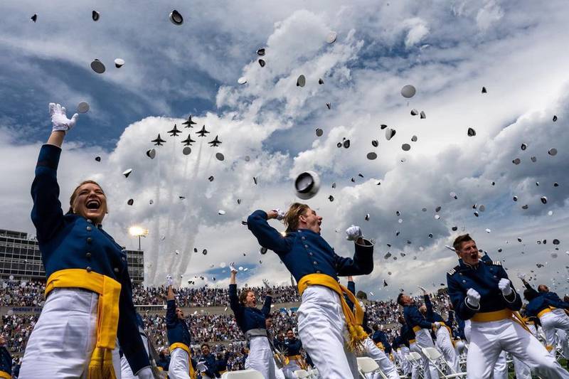 U.S. Air Force Academy cadets toss their caps at the end of a graduation ceremony in Colorado Springs, Colorado. More than 1,000 young adults graduated from the school on May 26, 2021. (Air Force photo)