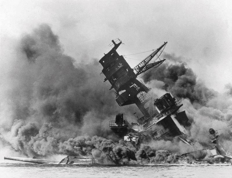 In this photo provided by the U.S. Navy, smoke rises from the battleship USS Arizona as it sinks during the Japanese attack on Pearl Harbor, Hawaii, Dec. 7, 1941.