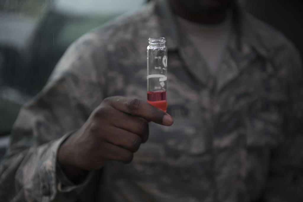 An airman tests water for chemicals at Barksdale Air Force Base, La.