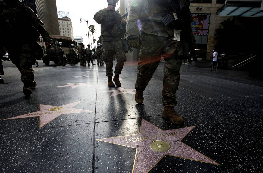 Members of National Guard walk past Donald Trump's star on the Hollywood Walk of Fame on Tuesday, June 2, 2020, in the Hollywood section of Los Angeles.