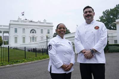 Air Force Master Sgt. and chef Opal Poullard, left, and Marine Corps Gunnery Sgt. and chef Dustin Lewis, right, pose for a photo at the White House in Washington, Friday, June 30, 2023.