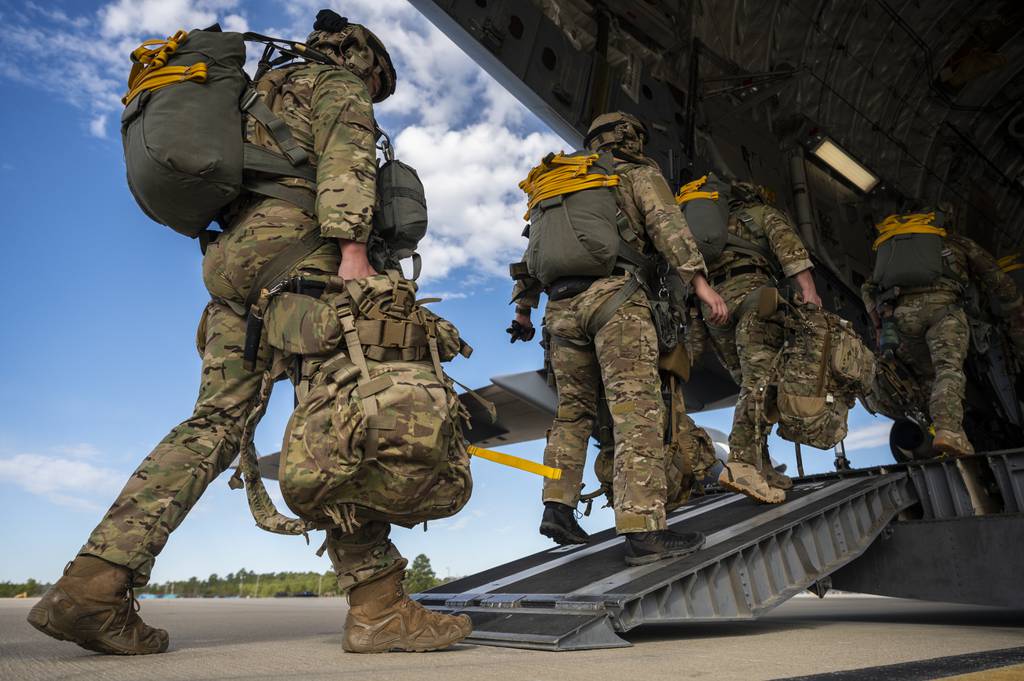 Special tactics airmen walk onto a C-17 cargo plane