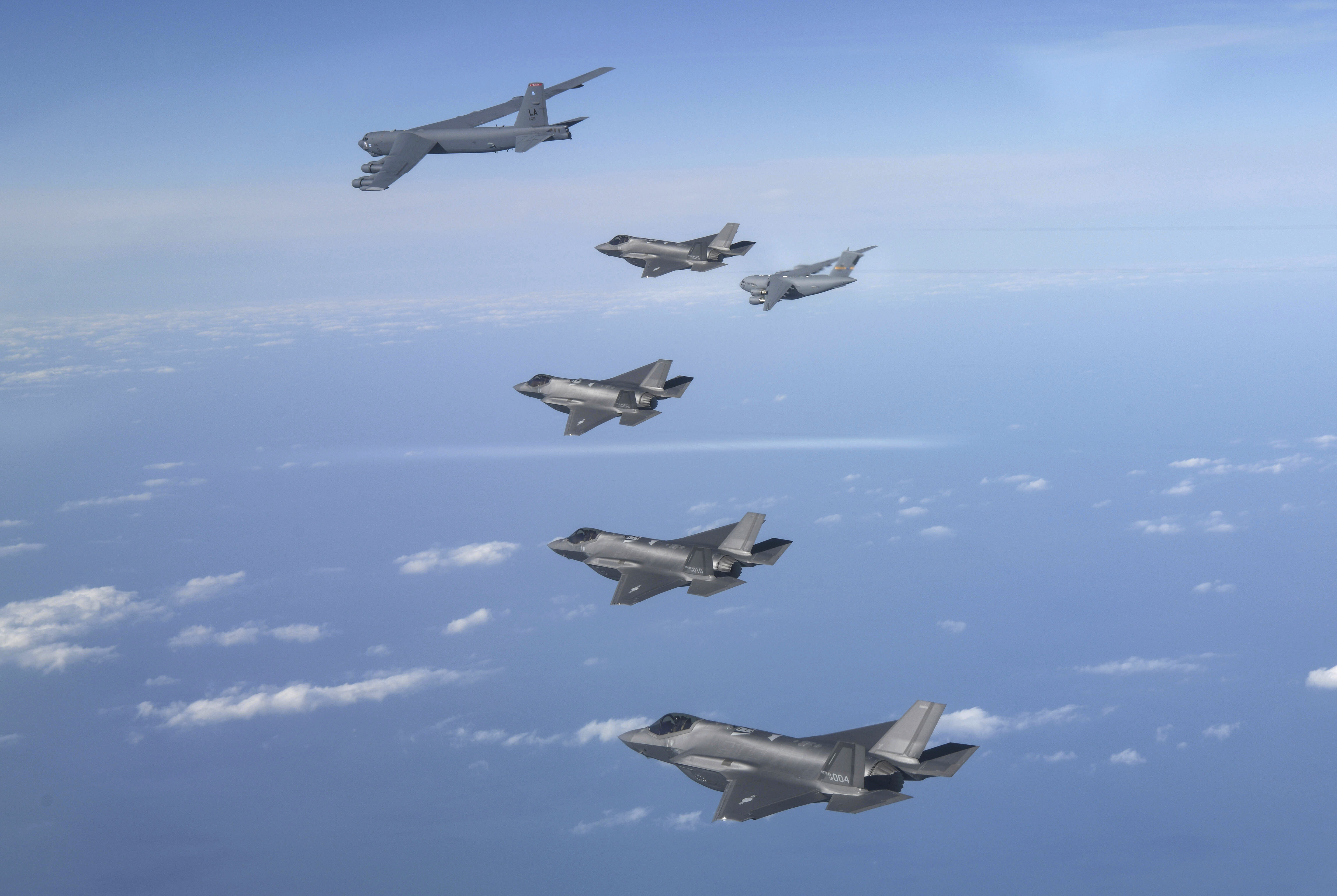 In this photo provided by South Korean Defense Ministry, A U.S. B-52 bomber, C-17 and South Korean Air Force F-35 fighter jets fly over the Korean Peninsula during a joint air drill in South Korea, Tuesday, Dec. 20, 2022.
